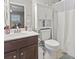 Well-appointed bathroom with linen cabinet and tub at 1400 Rainsbrook Ct., Conway, SC 29526