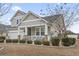 Two-story home with front porch and landscaping at 1400 Rainsbrook Ct., Conway, SC 29526