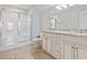 Bright bathroom showcasing a double vanity with granite countertop and enclosed shower at 1514-A S Ocean Blvd., Surfside Beach, SC 29575