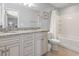 Well-lit bathroom with a granite vanity, tile flooring, and a glass shower enclosure at 1514-A S Ocean Blvd., Surfside Beach, SC 29575