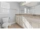 Bright bathroom featuring double sinks, granite countertops, and a shower with tub at 1514-A S Ocean Blvd., Surfside Beach, SC 29575