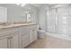 Bathroom showcasing a double vanity, tile flooring, and a glass shower enclosure at 1514-A S Ocean Blvd., Surfside Beach, SC 29575