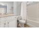 Well-lit bathroom featuring a granite countertop vanity and a shower with tub at 1514-A S Ocean Blvd., Surfside Beach, SC 29575