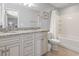 Bathroom with granite countertop, double sinks, and bathtub at 1514-A S Ocean Blvd., Surfside Beach, SC 29575