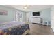 Large bedroom featuring neutral paint, french doors, and a mounted television at 1514-A S Ocean Blvd., Surfside Beach, SC 29575