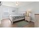 Cozy bedroom with wood-look flooring, ceiling fan, and bright natural light at 1514-A S Ocean Blvd., Surfside Beach, SC 29575