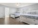 Bright bedroom with twin beds, wood-look floors, and ensuite bath access at 1514-A S Ocean Blvd., Surfside Beach, SC 29575