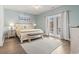 Bright bedroom with light-blue walls, hardwood floors, and access to a private balcony at 1514-A S Ocean Blvd., Surfside Beach, SC 29575