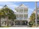 Beach house exterior, two stories, light beige with gray roof and multiple balconies at 1514-A S Ocean Blvd., Surfside Beach, SC 29575