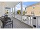 Covered porch with chairs, overlooking a neighbor's yard and swimming pool at 1514-A S Ocean Blvd., Surfside Beach, SC 29575