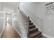 Traditional staircase with white spindles, wood railing, and wood-look flooring at 1514-A S Ocean Blvd., Surfside Beach, SC 29575