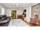 Cozy living room features a brick accent wall and ample natural light at 155 Busbee St., Conway, SC 29526