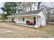 White workshop with covered porch and lawn mower at 155 Busbee St., Conway, SC 29526