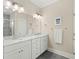 Bright bathroom featuring double sinks, marble countertop, and separate shower at 1625 Crosswinds Ave., North Myrtle Beach, SC 29582