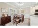 Bright dining area with hardwood floors and charming table setting next to the kitchen at 1625 Crosswinds Ave., North Myrtle Beach, SC 29582