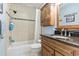 Bathroom with shower/tub combo, granite countertop, and wood cabinets at 1671 Arundel Rd., Myrtle Beach, SC 29577