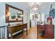 Bright entryway with hardwood floors, console table, and piano at 1671 Arundel Rd., Myrtle Beach, SC 29577