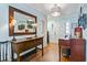 Bright entryway with hardwood floors, console table, and piano at 1671 Arundel Rd., Myrtle Beach, SC 29577