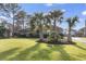 Brick house with palm trees and well-manicured lawn at 1671 Arundel Rd., Myrtle Beach, SC 29577