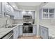 Modern kitchen with stainless steel appliances and granite countertops at 1801 N Ocean Blvd. # F-1, North Myrtle Beach, SC 29582