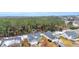 Aerial view of a house in a residential neighborhood, with surrounding trees and light snow at 184 Retreat Pl., Little River, SC 29566