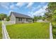 Spacious backyard featuring a white picket fence, patio, and lush green grass at 184 Retreat Pl., Little River, SC 29566