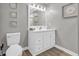 Updated bathroom features a white vanity with modern fixtures and a decorative mirror at 184 Retreat Pl., Little River, SC 29566