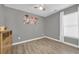 Cozy bedroom featuring natural light, wood floors, and neutral wall colors at 184 Retreat Pl., Little River, SC 29566