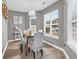 Bright dining area with wood flooring, stylish light fixture, and large windows overlooking the outdoors at 184 Retreat Pl., Little River, SC 29566