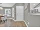 Gray walls and hardwood floors, white door to the kitchen at 184 Retreat Pl., Little River, SC 29566