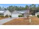 Gray house with a white garage door and small front yard at 184 Retreat Pl., Little River, SC 29566