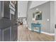 Inviting entryway with wood flooring, a blue accent table, and views of the open-concept living area at 184 Retreat Pl., Little River, SC 29566