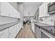 Open concept kitchen with granite countertops, stainless steel appliances, and view into the living area at 184 Retreat Pl., Little River, SC 29566