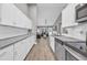 Modern kitchen with white cabinets and granite countertops at 184 Retreat Pl., Little River, SC 29566