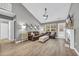 Inviting living room with vaulted ceiling, hardwood floors, leather sofas, and a cozy fireplace at 184 Retreat Pl., Little River, SC 29566