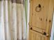 Bathroom with wood door and leaf-print shower curtain at 187 Stephen Dr., Hemingway, SC 29554