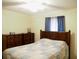 Bedroom with wood dresser and blue and tan bedding at 187 Stephen Dr., Hemingway, SC 29554