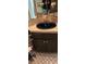 Corner vanity sink with dark brown cabinet in a bathroom at 1919 Spring St. # B11, North Myrtle Beach, SC 29582