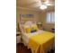 Bright bedroom with yellow comforter and ceiling fan at 1919 Spring St. # B11, North Myrtle Beach, SC 29582