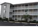 Three-story building with balconies and ample parking at 1919 Spring St. # B11, North Myrtle Beach, SC 29582