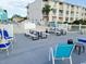 Community pool deck with picnic tables and chairs at 1919 Spring St. # B11, North Myrtle Beach, SC 29582