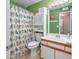 Small bathroom with green walls and a bird-themed shower curtain at 1943 Bent Grass Dr. # H, Myrtle Beach, SC 29575