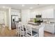 Bright kitchen featuring white cabinets, stainless steel appliances, and a granite countertop island with barstool seating at 195 Talladega Dr. # 430, Myrtle Beach, SC 29579