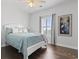 Bright bedroom with white bedding, hardwood floors, and window with plantation shutters at 200 53Rd Ave. N # 501, North Myrtle Beach, SC 29582