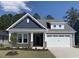 Charming new construction home with a two-car garage, landscaped yard, and welcoming front porch at 2163 Gooseberry Way, Longs, SC 29568