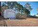 White storage shed with roll-up door in backyard at 230 Kellys Cove Dr., Conway, SC 29526