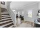 Bright and spacious entryway with wooden stairs and a view into the living area at 2360 Goldfinch Dr., Myrtle Beach, SC 29577