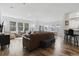 Spacious living room with brown leather sectional sofa and kitchen view at 2360 Goldfinch Dr., Myrtle Beach, SC 29577