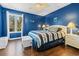 Cozy bedroom featuring a blue and white striped bedding set and wood flooring at 2409 Royal Oak Circle, North Myrtle Beach, SC 29582