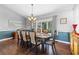 Bright dining room with hardwood floors, large windows, and elegant dining set at 2409 Royal Oak Circle, North Myrtle Beach, SC 29582